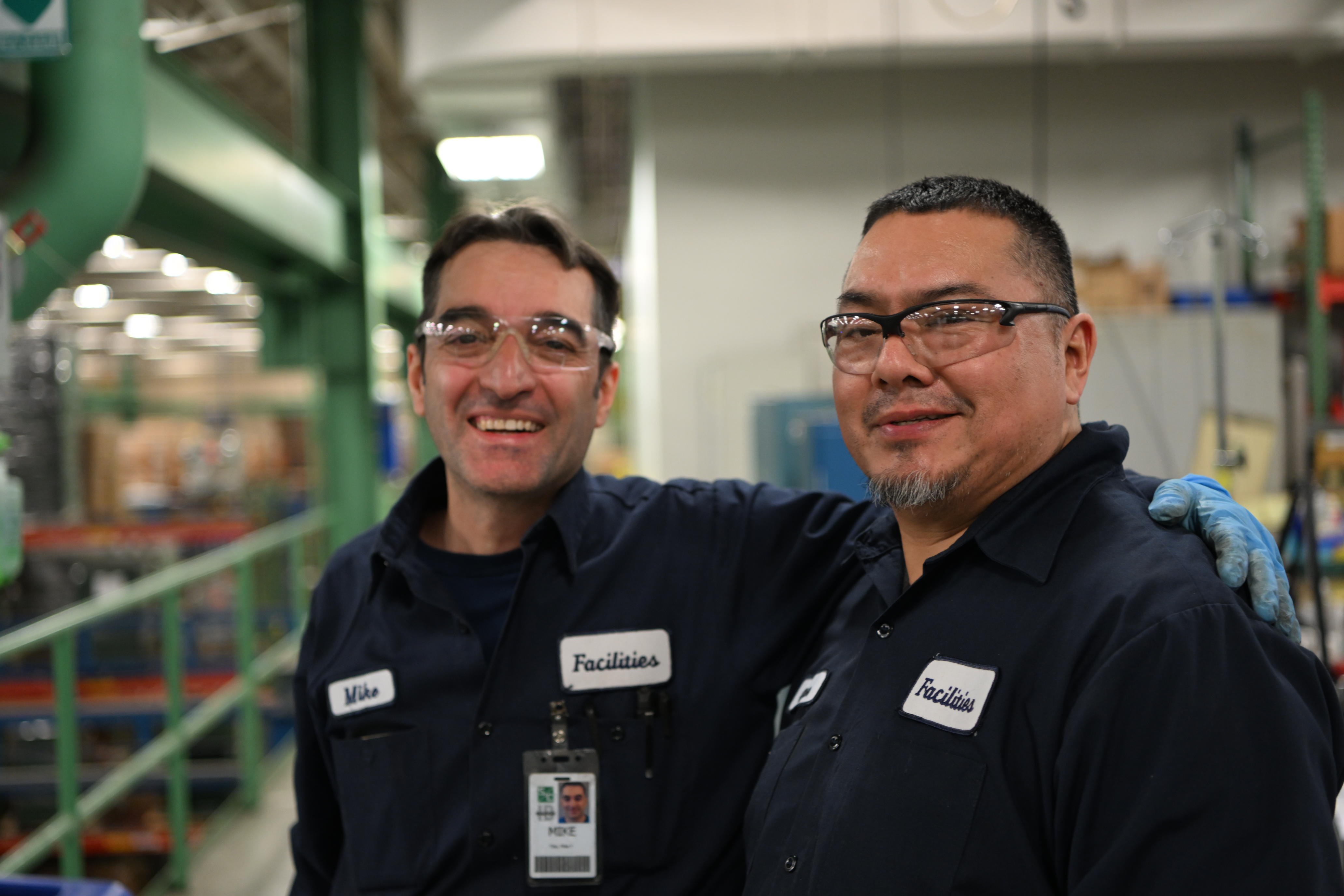 Two team members smile for the camera in S&C's manufacturing facility in Chicago, IL. 