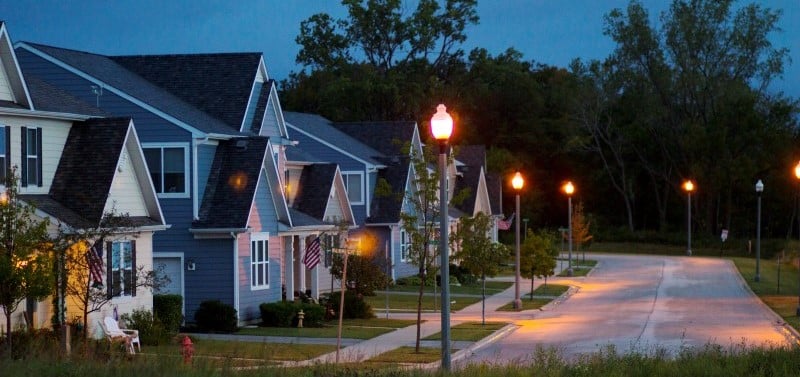 houses with streetlights lit up