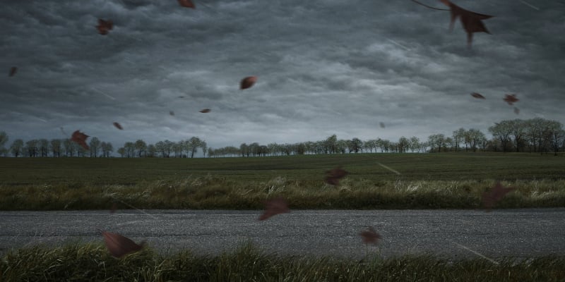 storm over a parking lot and grassy field