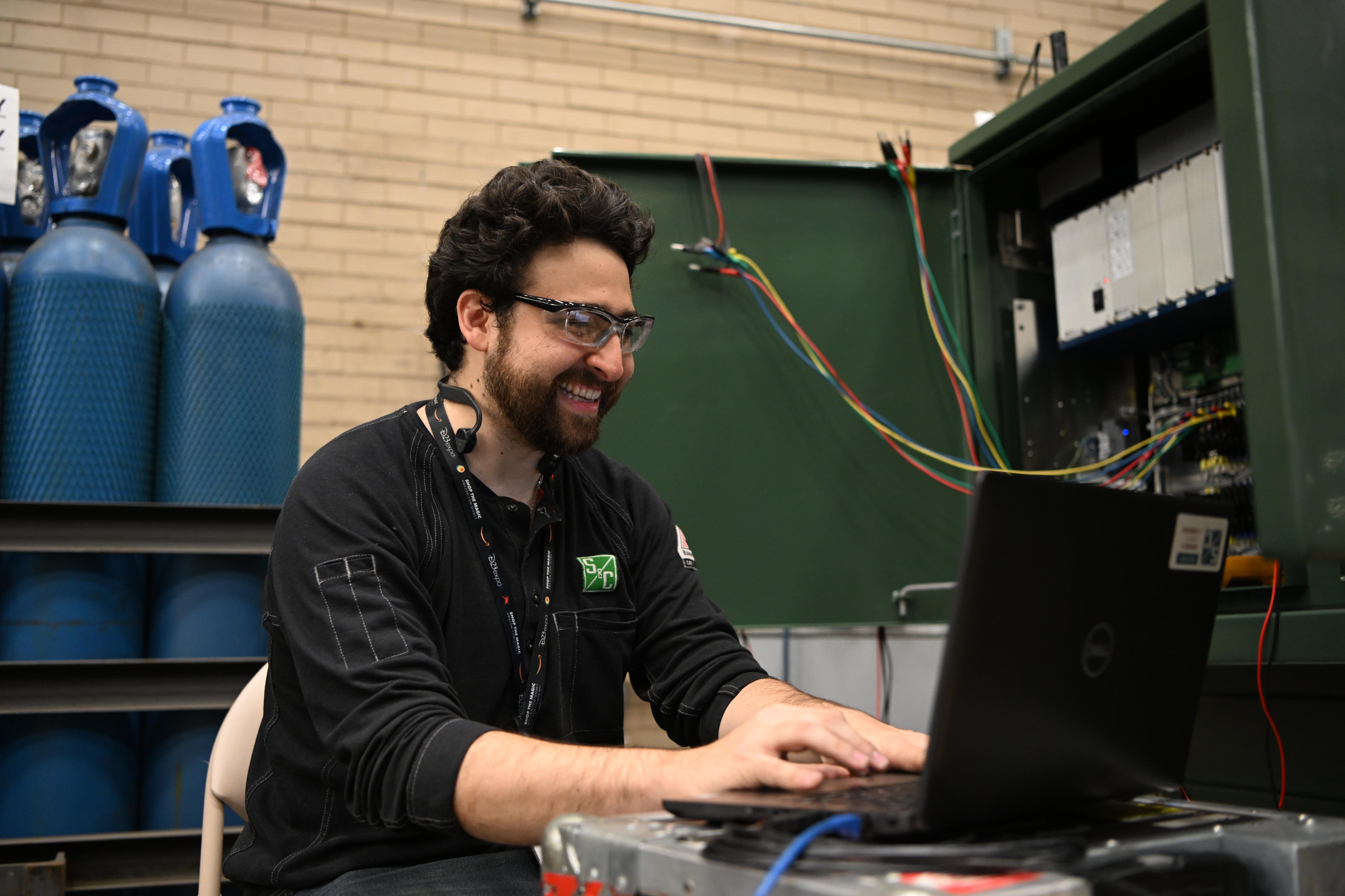 A smiling team member performs data analysis 