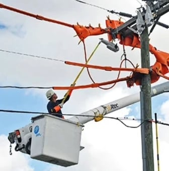 an FPL lineman on a bucket installing a recloser opens case study on eighty thousand reclosers combat nations toughest weather